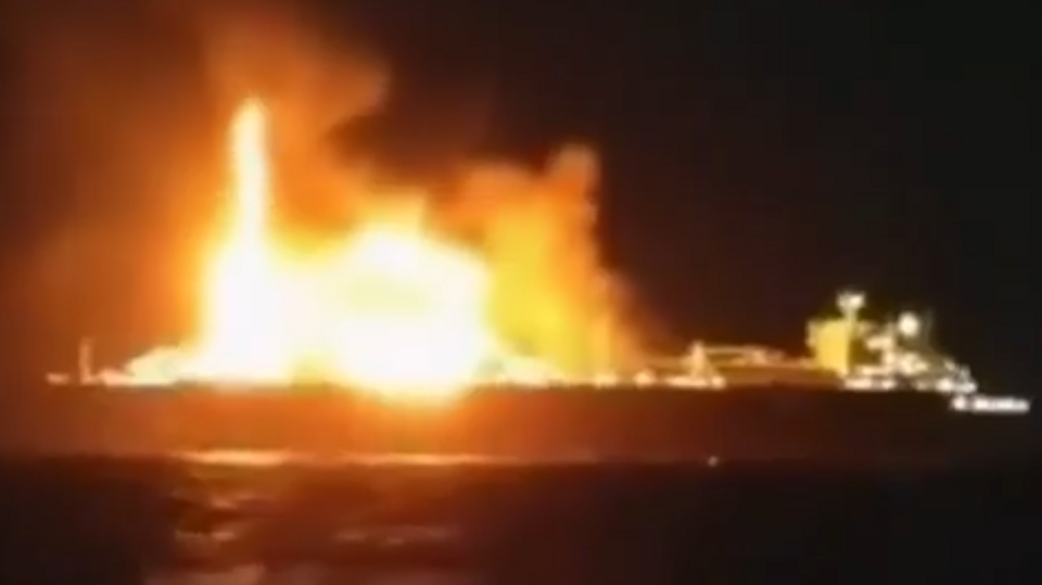 A ship on fire in the dark