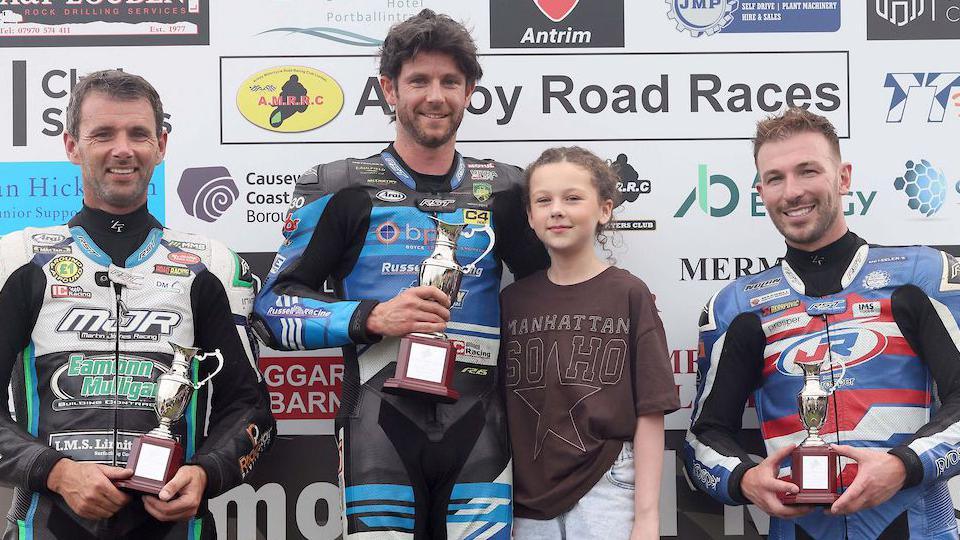 Mike Browne flanked by Michael Sweeney and Paul Jordan at Armoy road races