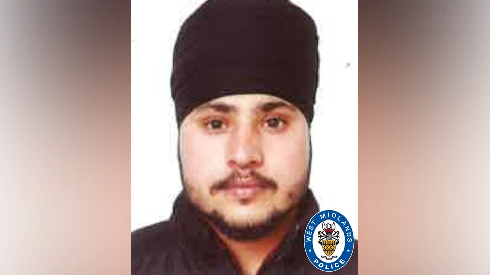 Mr Singh is pictured with a black turban on and beard and dark top. He is slightly smiling at the camera.