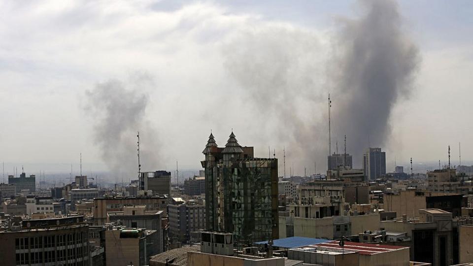 Smoke rises after an airstrike in Tehran