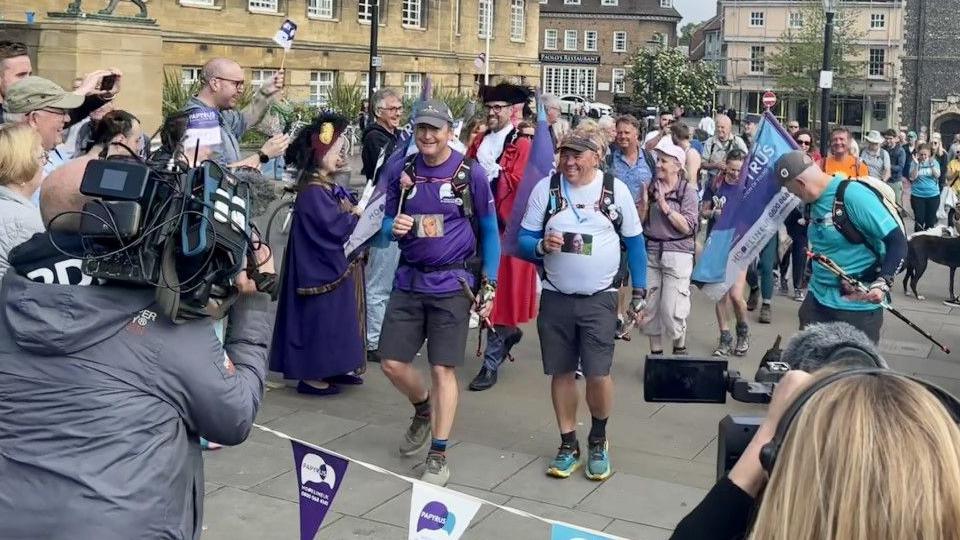 Three men cross the finish line in Norwich