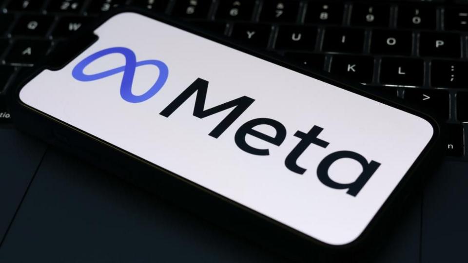 The Meta logo is displayed on a mobile phone