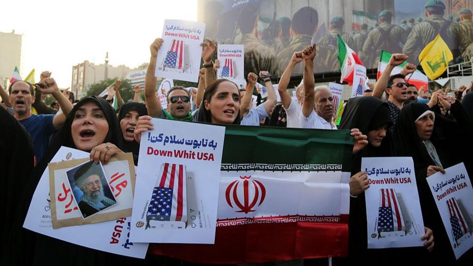 Crowds holding Iranian flags gather in the Revolution Square in the capital Tehran to protest the US attacks on three nuclear facilities in Iran on June 22, 2025.