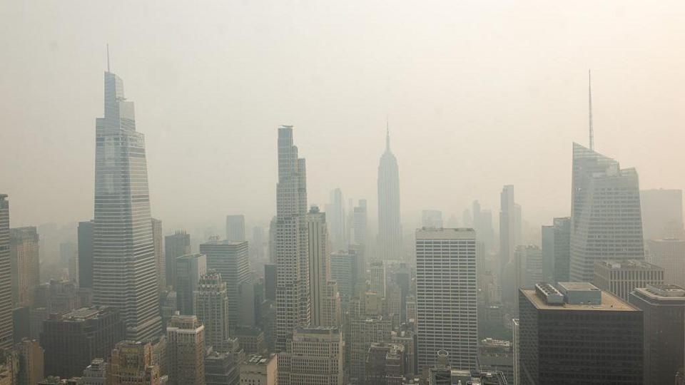 The New York City skyline is seen with a thick haze of smoke