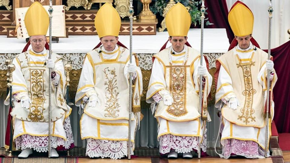 (L-R) Catholic priests Pascal Schreiber of Switzerland, Michael Goldade of United States, Michel Poinsinet de Sivry of France, and Marc Hanappier of France wear the bishop's mitre after receiving episcopal consecration during a pontifical mass organized by Society of Saint Pius X (SSPX) in Econe, near Sion, Switzerland.