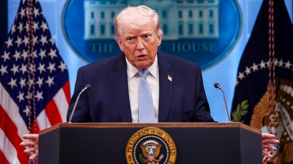 Donald Trump speaks from a podium.