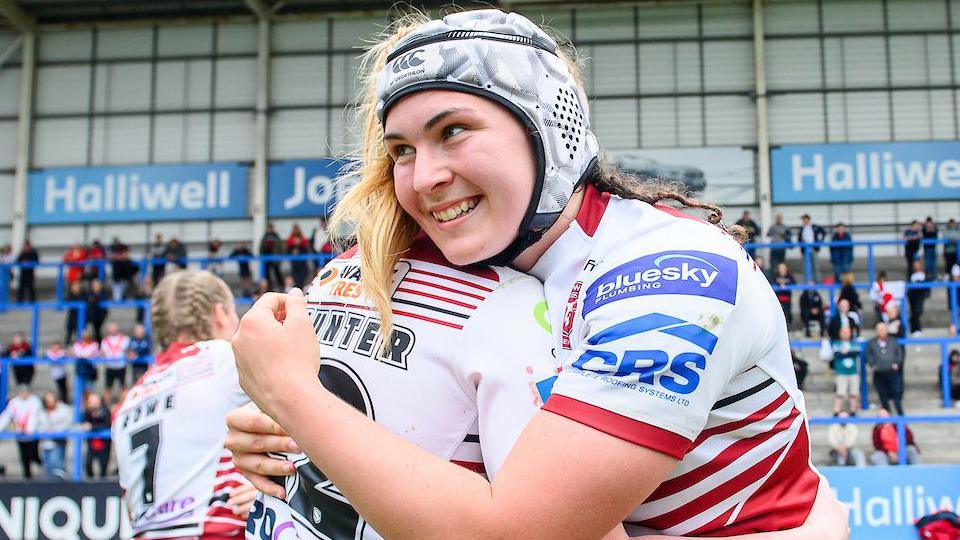 Megan Williams celebrates another win for Wigan Warriors and she scored two tries in their 56-12 victory over Huddersfield Giants.