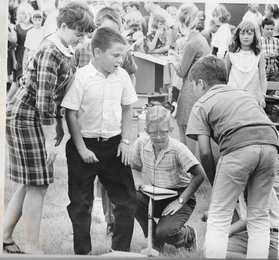 A black and white image of Paul and other pupils at Cape View Elementary in the 1960s with a model rocket.