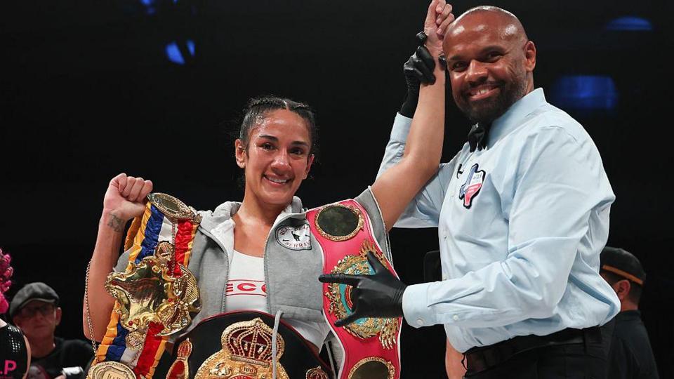 Amanda Serrano with her titles