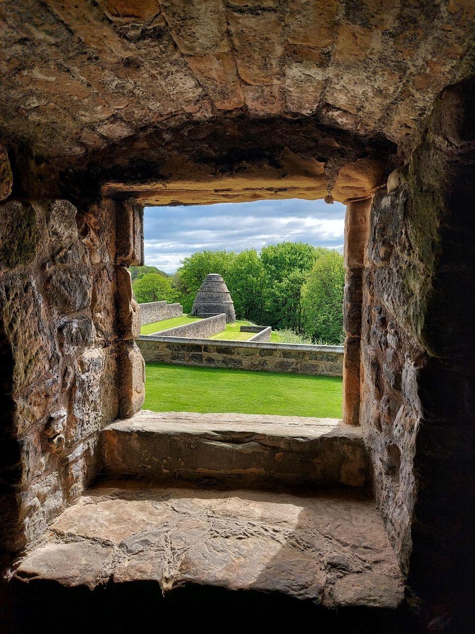 A stone alcove overlooking a garden