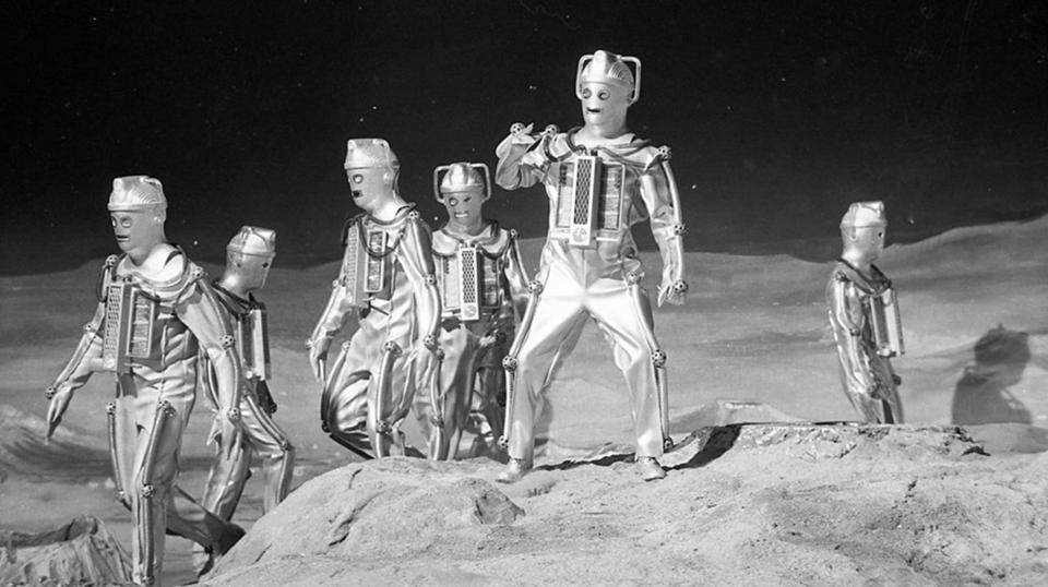 People dressed in alien suits