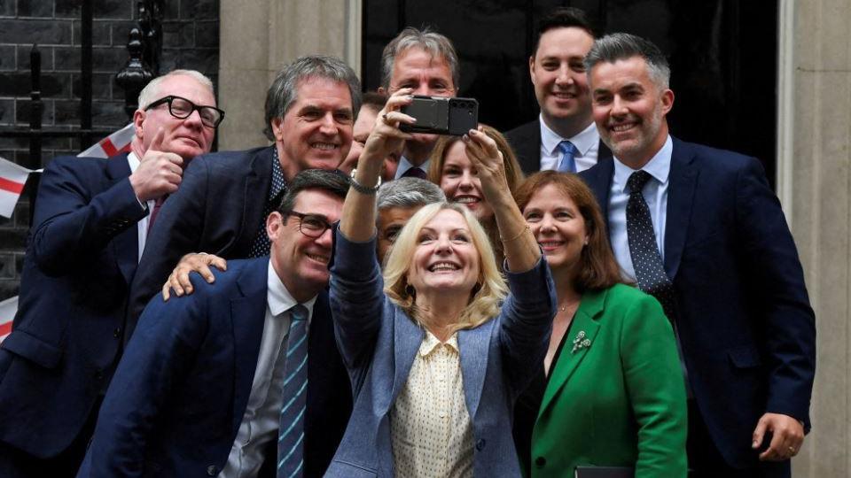 A group of regional mayors lining up for a selfie on the doorstep of Downing Street