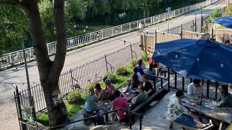 Customers sat outside at the Engineers' House, on the Riverside in Cambridge