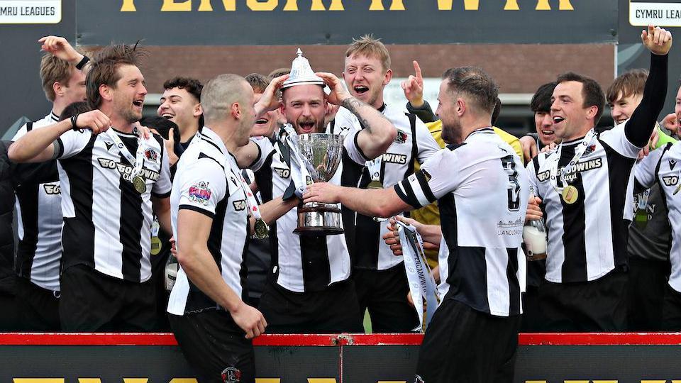 Llandudno players celebrate with the Cymru North trophy