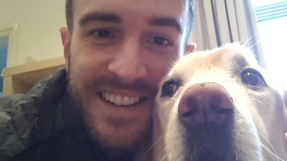 Gavin Sims with his mother's retired guide dog Poppy