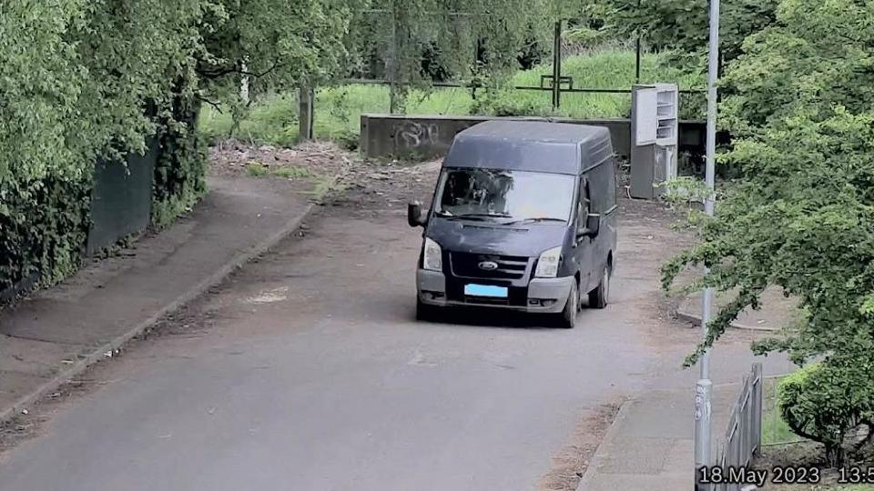 CCTV capturing illegal disposal of a grey fridge freezer