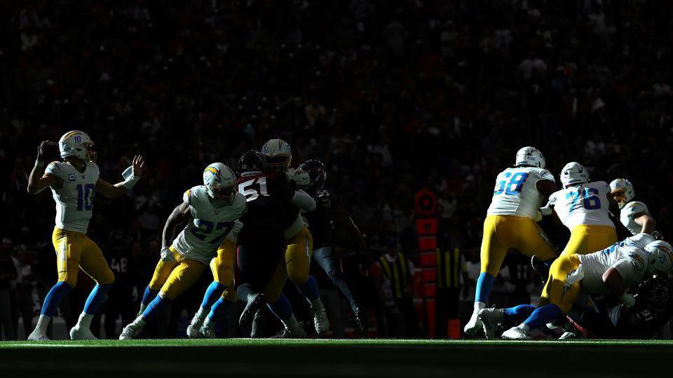 Justin Herbert of the Los Angeles Chargers throws a pass during the first quarter of the game against the Houston Texans during the AFC Wild Card Playoffs at NRG Stadium in Houston, Texas