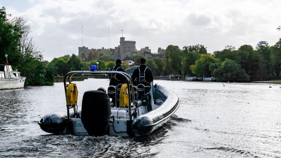 A police boat on the River Thames with Windsor Castle in the background