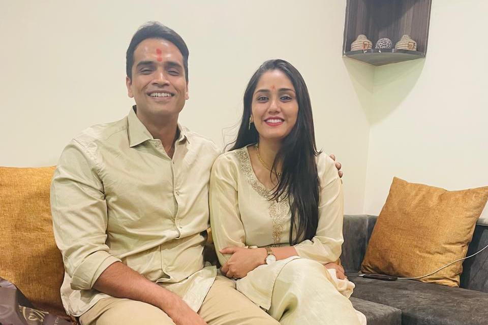 Twisha with husband Samarth - both of them are dressed in yellow shirts and pants