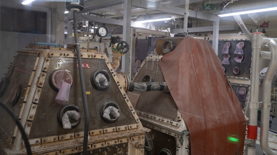 A redundant glovebox in Sellafield's analytical services laboratories. They are large structure with welded joins and several openings with gloves attached. They look like sets from a 1960s sci-fi TV show.