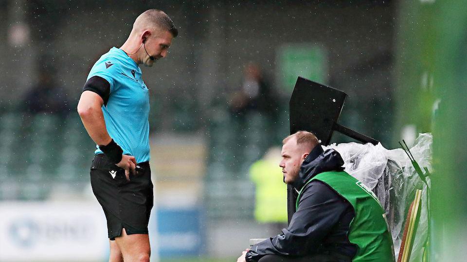 Referee checks the VAR monitor in the first half at Park Hall.