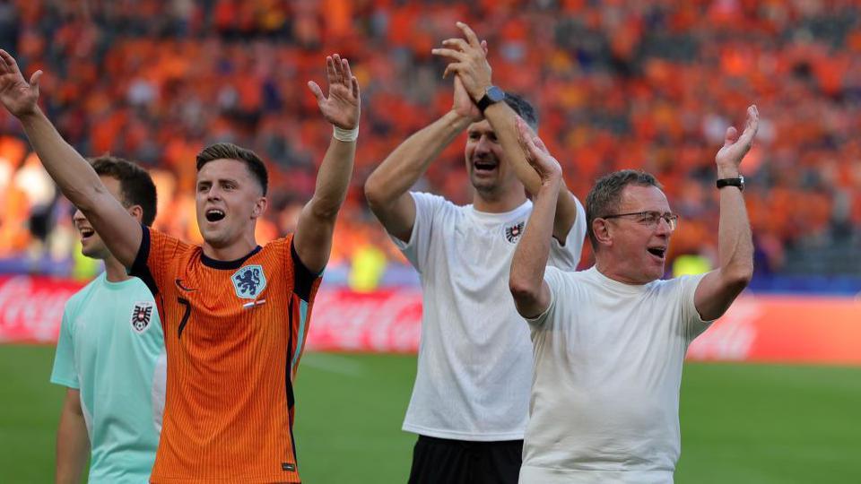 Ralf Rangnick and his Austria players celebrate their win against the Netherlands