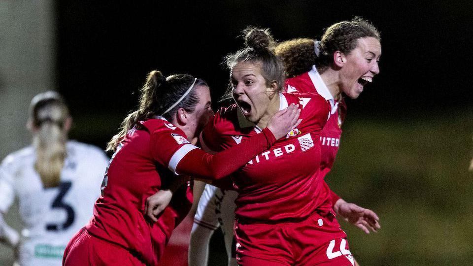 Keren Allen celebrates the winning goals with Wrexham team-mates