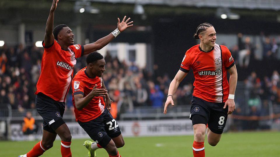 Luton Town players celebrate with Theo Aasgaard following his goal against Bristol City earlier this month