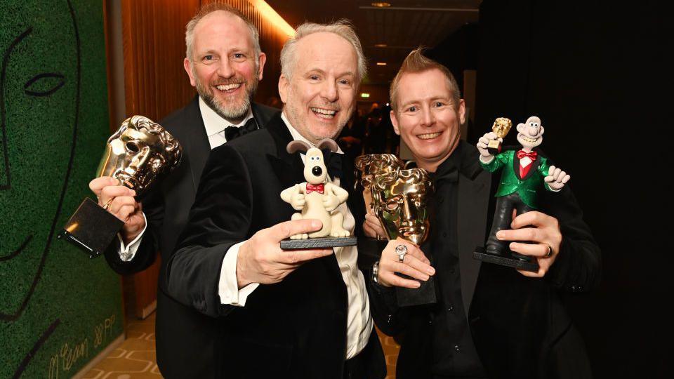 Richard Beek and Nick Park and Merlin Crossingham with awards