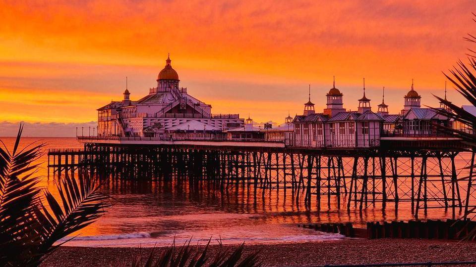 Eastbourne Pier under an orange sunset 