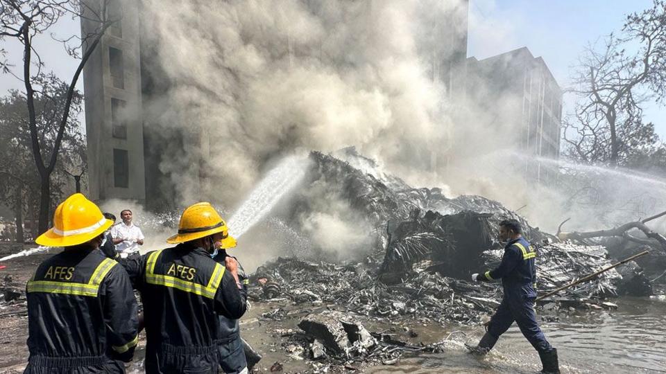Firefighters spray water on wreckage in Ahmedabad