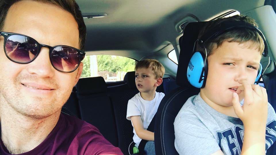 James Hunt, in the car with his two sons. One is in the front wearing headphones.