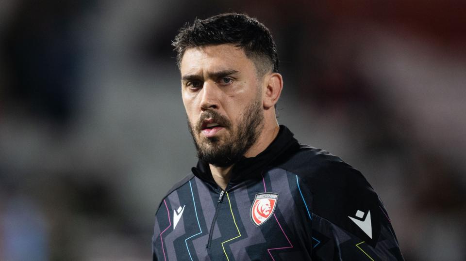 Gloucester rugby lock Matias Alemanno looks on during the warm-up for a Premiership Rugby game, wearing a black quarter-zip training top