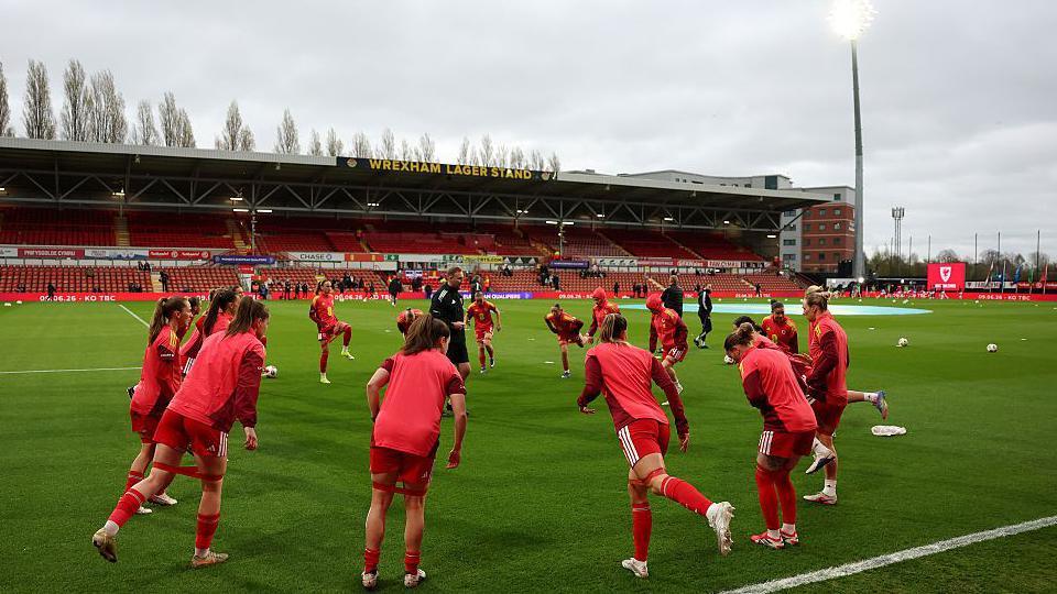 Wales women warming up on the Stok Cae Ras pitch