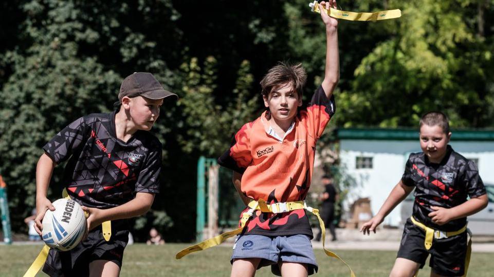 Children compete for the ball during Ukrainian Children's Tag Rugby League game