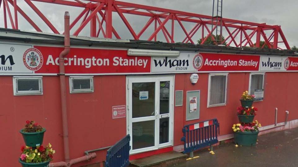 Accrington Stanley Football Club entrance. A one storey building in red and white