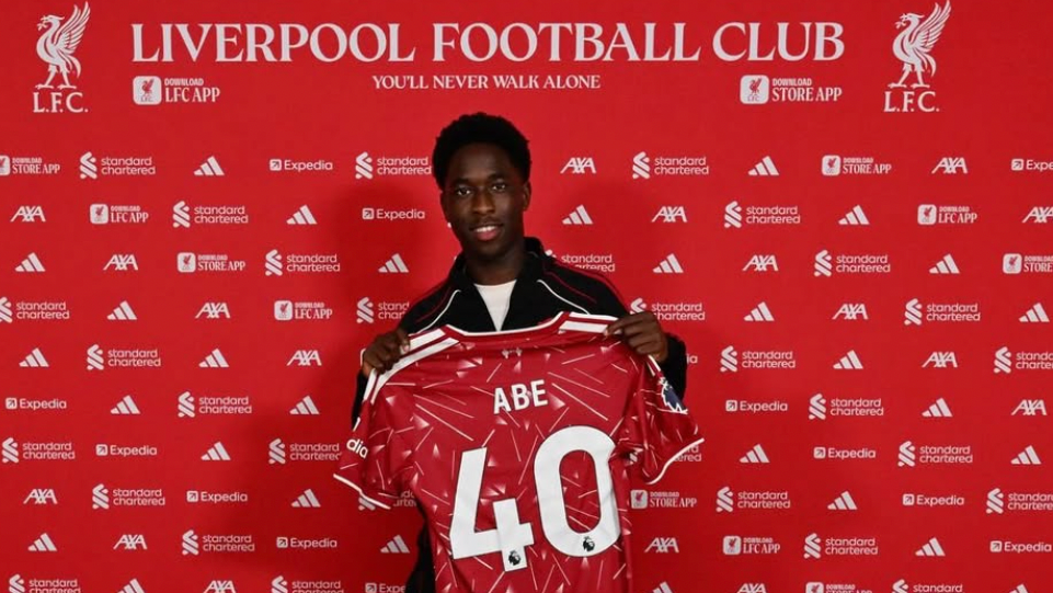 Josh Abe holding his Liverpool shirt with the number 40 on the back