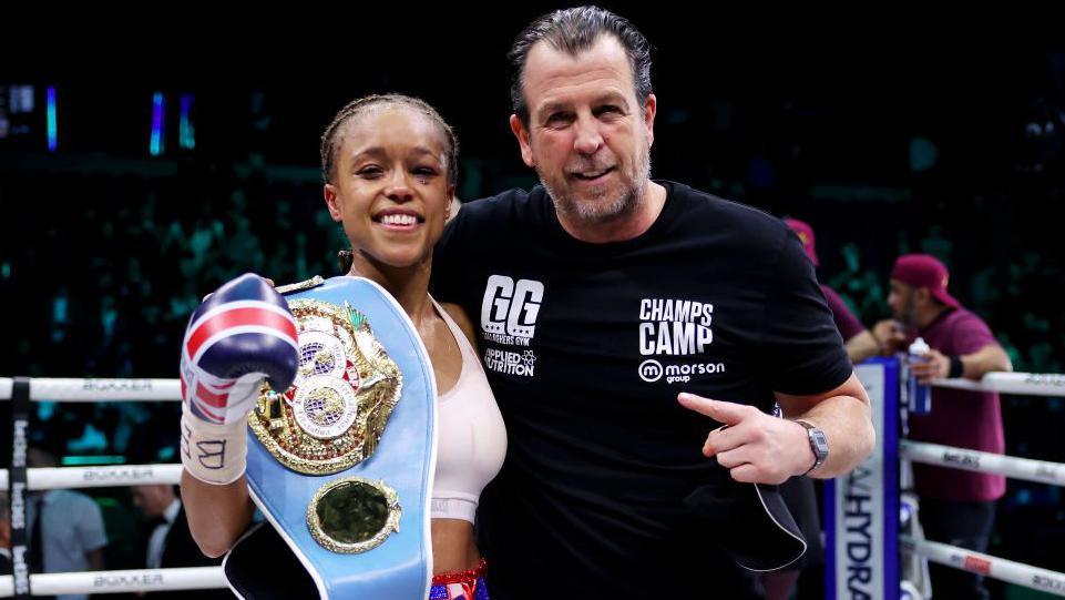 Natasha Jonas poses with belts and trainer Joe Gallagher