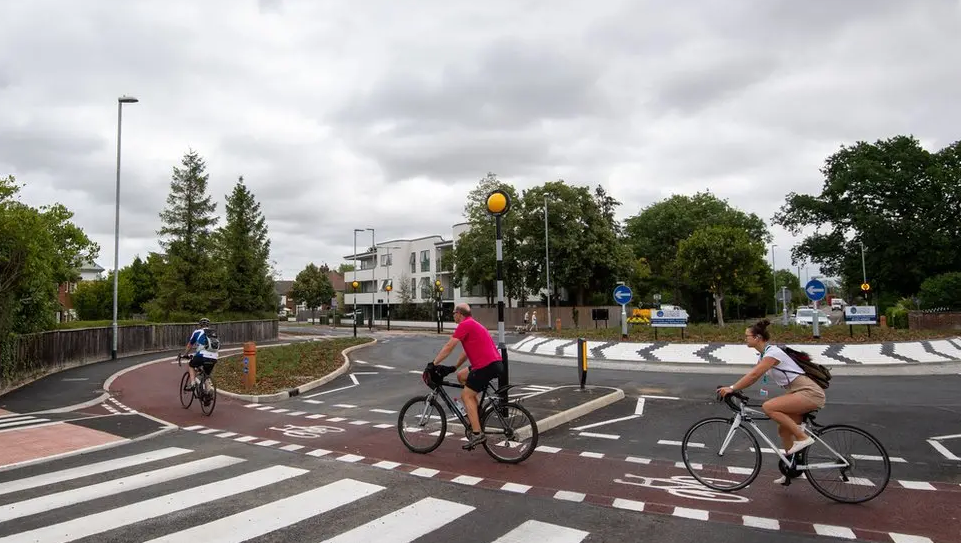 The roundabout, showing cyclists using the outer red orbital path