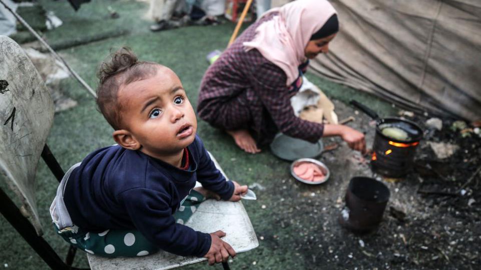 Palestinian children at a camp set up in Al-Durra Stadium in the central Gaza Strip 