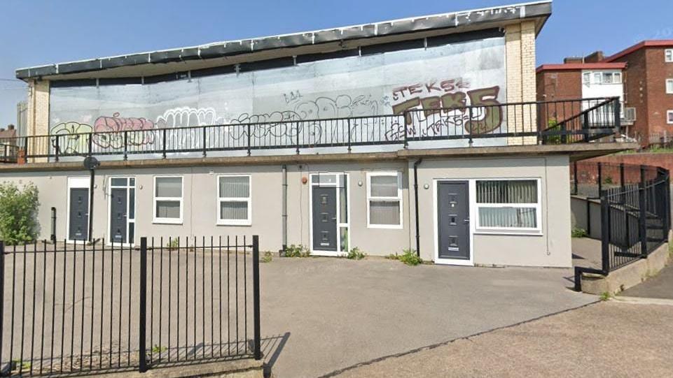 View of the boarded-up windows of the closed Byard's Leap pub covered in graffiti