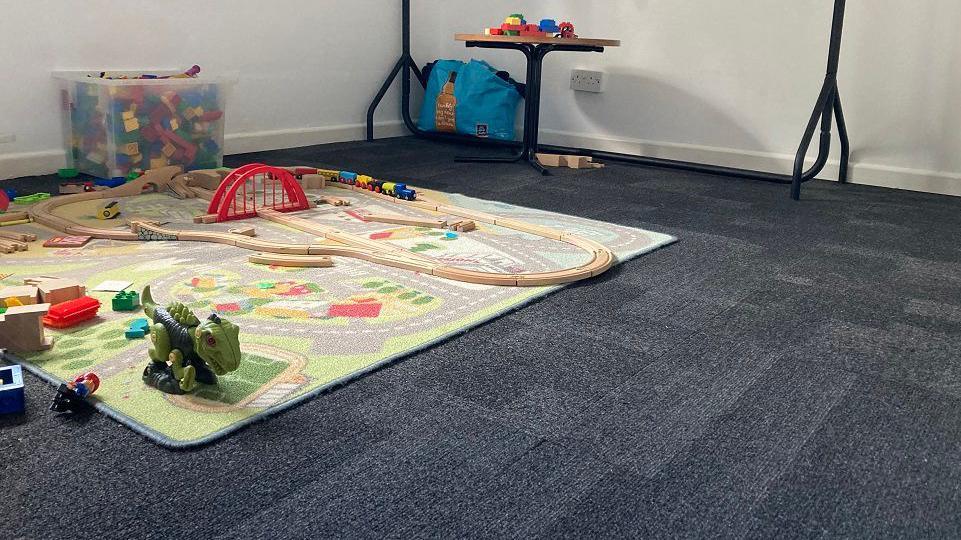 Carpeted floor with toy road track