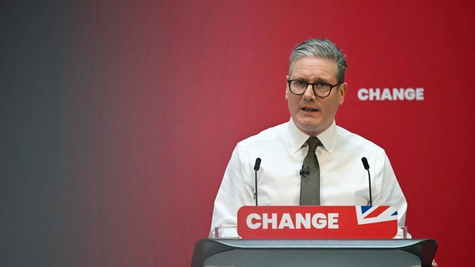 Labour leader Sir Keir Starmer standing in front of lectern