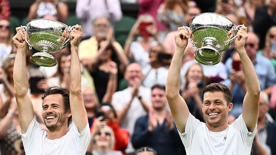 Wesley Koolhof and Neal Skupski lift the Wimbledon men's doubles trophy in 2023
