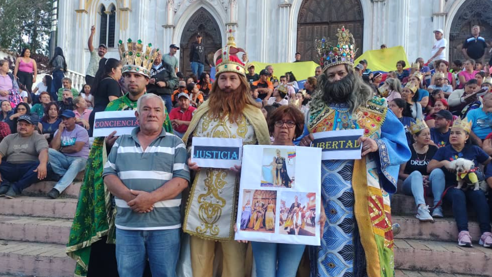 Members of Mr Hernández's family are joined by costumed, crown-wearing attendees at a vigil