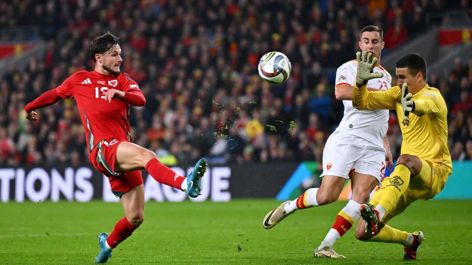 Liam Cullen attempting to lob Montenegro goalkeeper Igor Nikic