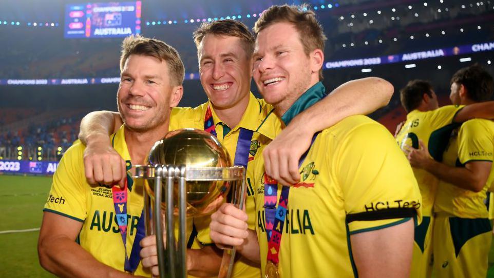 David Warner, Marnus Labuschagne and Steve Smith of Australia pose with the ICC Men's Cricket World Cup Trophy following the ICC Men's Cricket World Cup India 2023 Final between India and Australia at Narendra Modi Stadium on November 19, 2023 in Ahmedabad, India