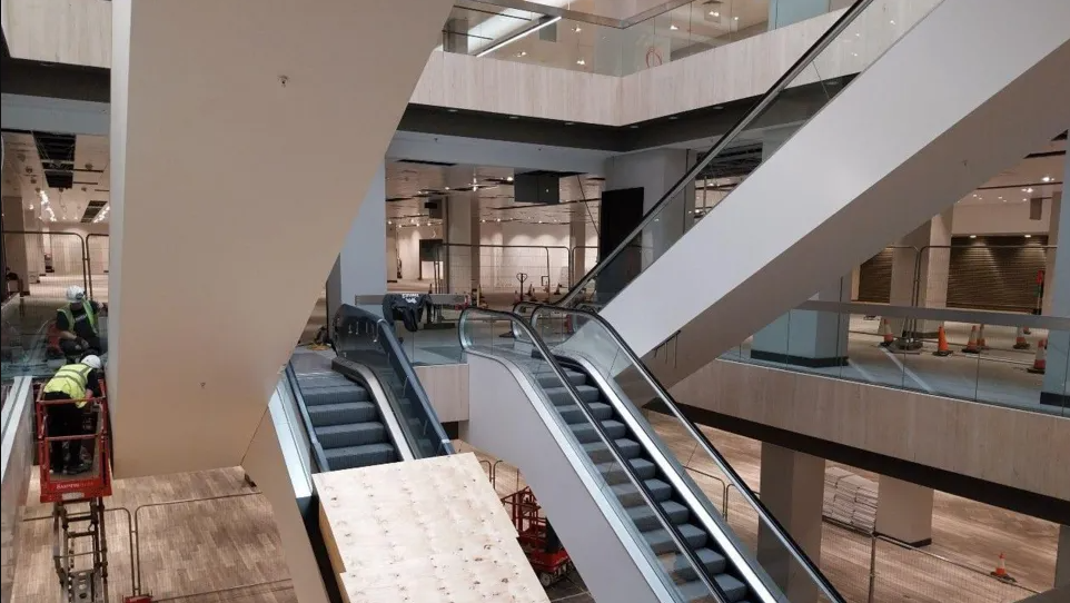 An under-construction shopping unit with escalators