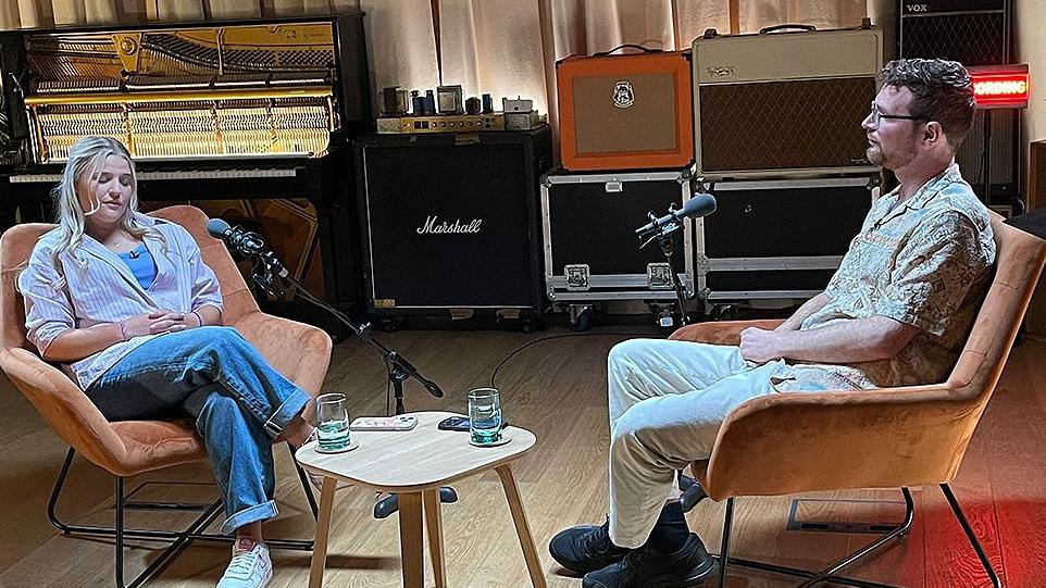 Gracie and Callum sitting in a recording studio to record their podcast