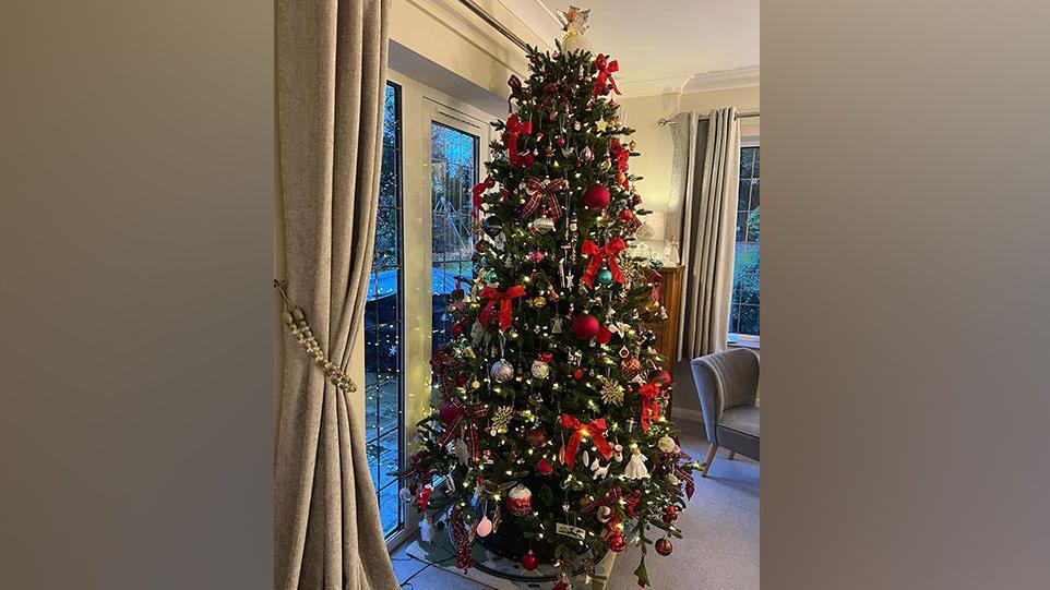 A Christmas tree with red, white and silver baubles. 